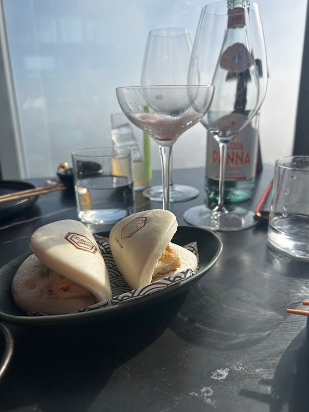 Very basic looking bao buns with a glimpse of tofu and green avocado paste - no garnish