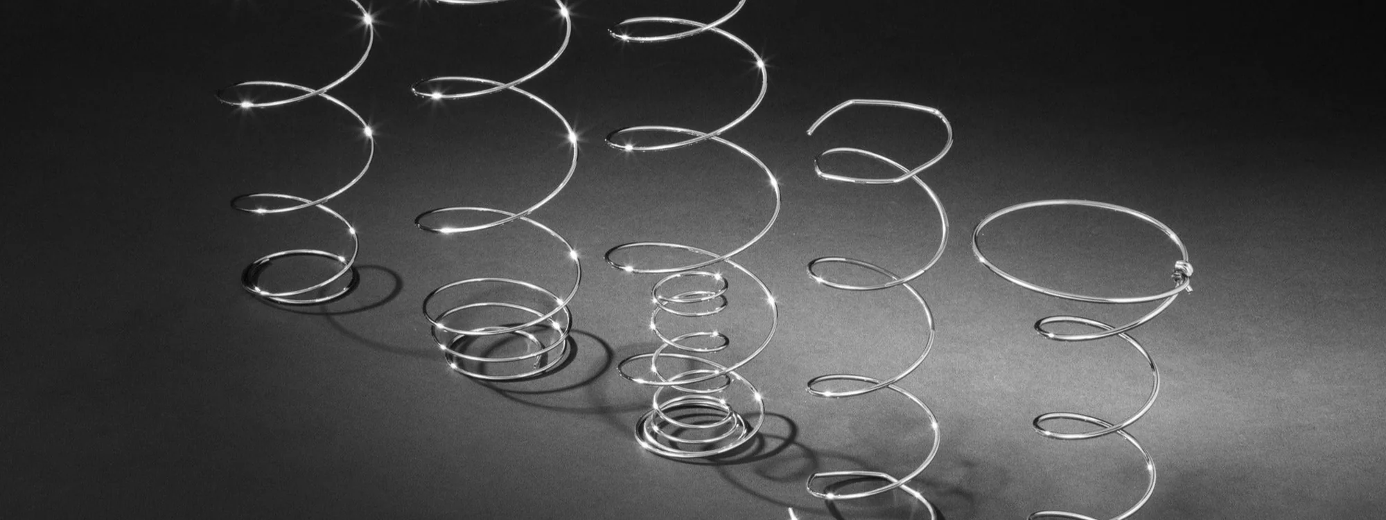 Metal springs of different shapes on a dark background