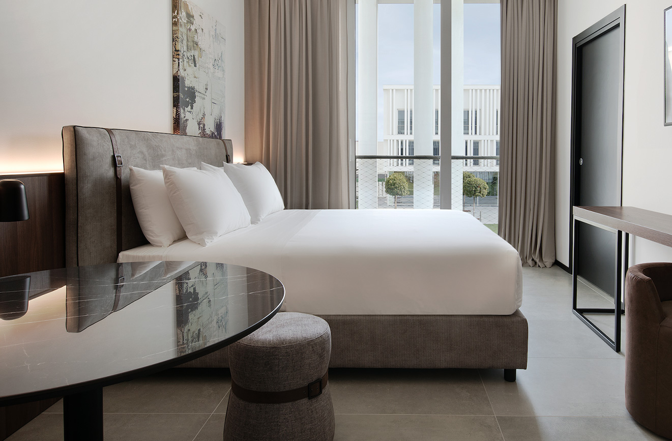 Modern hotel room with double bed and large window