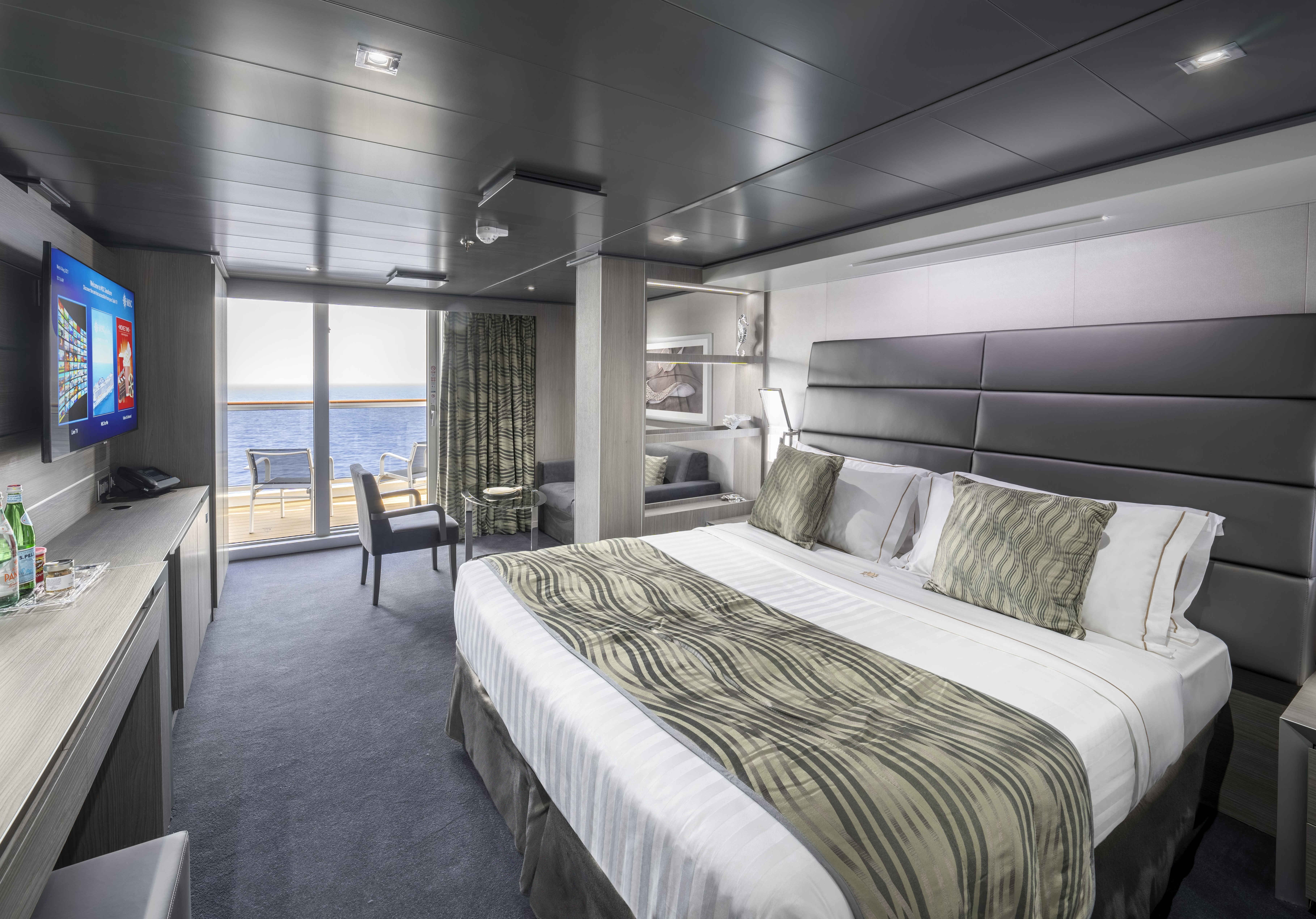 Cruise ship cabin with double bed and balcony