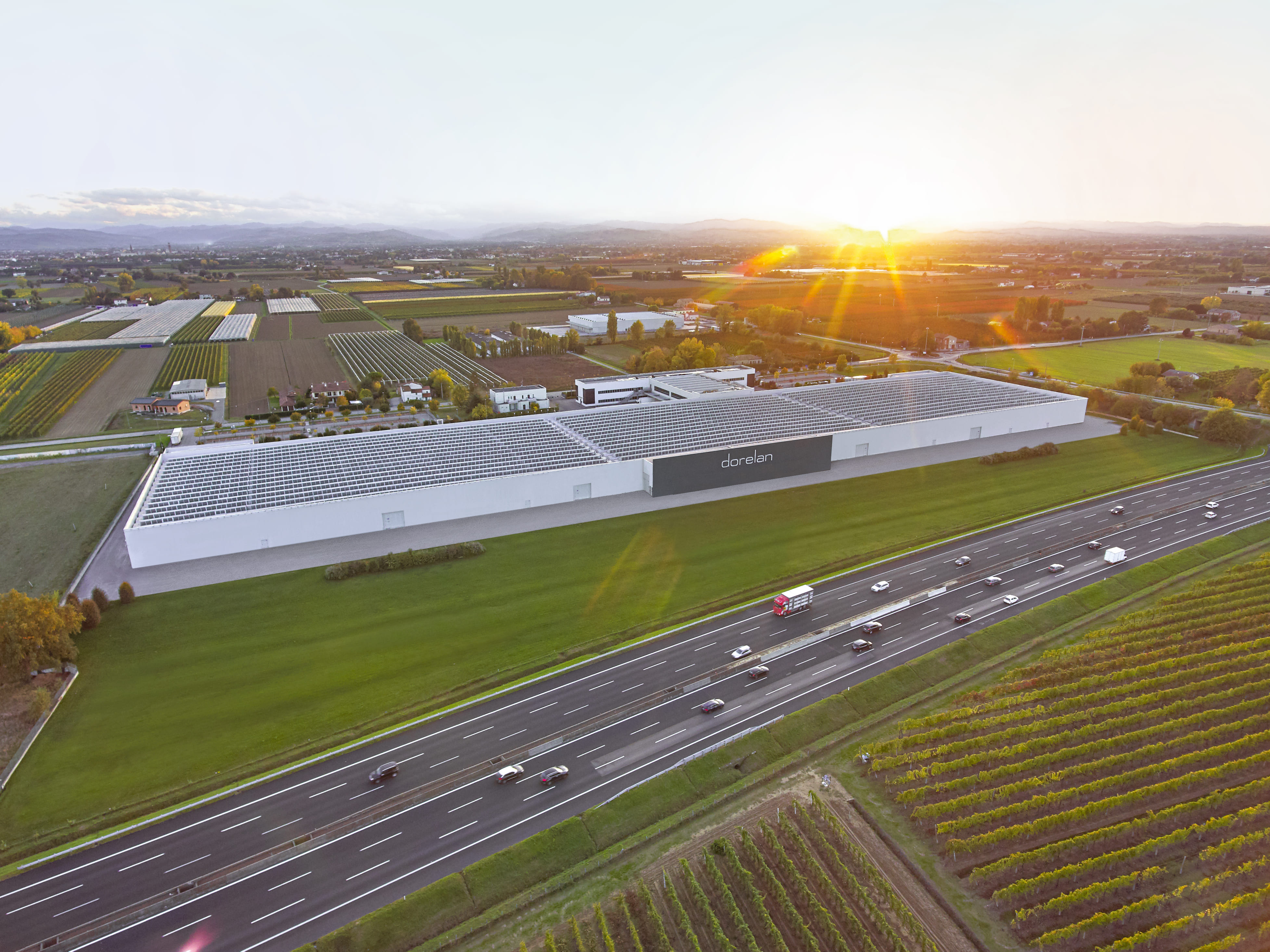 Aerial view of the Dorelan factory at sunset, among fields and vineyards