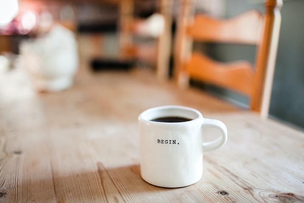 Une tasse de café sur laquelle est écrit "begin"