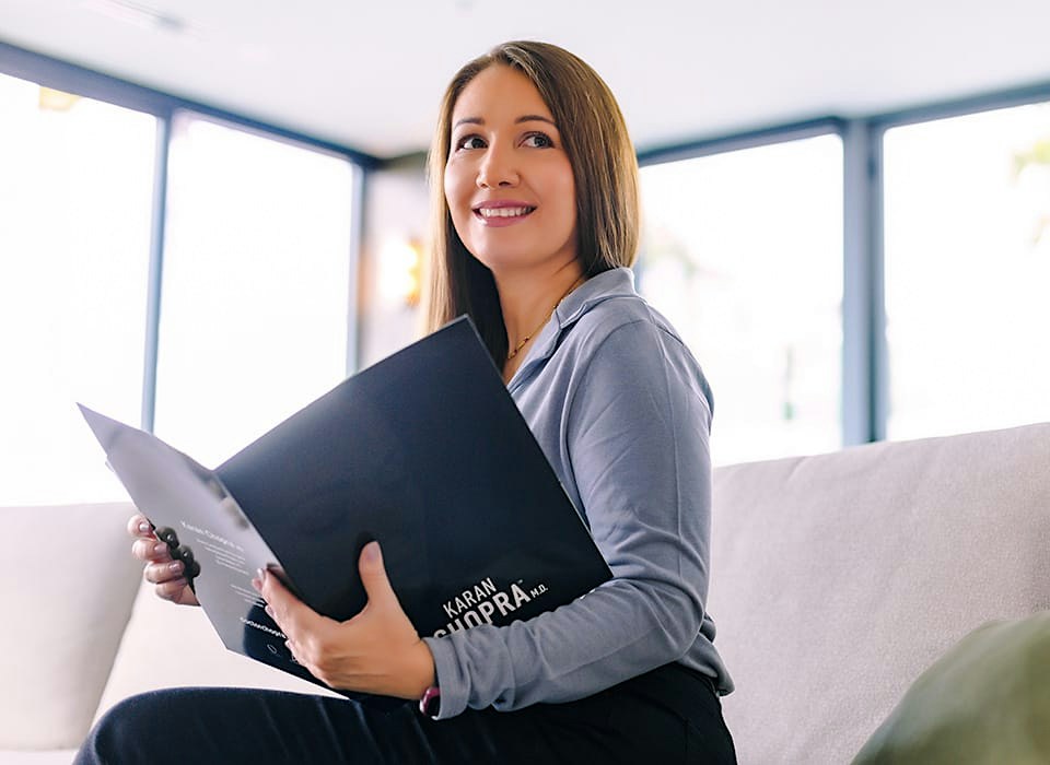 woman in blue holding folder