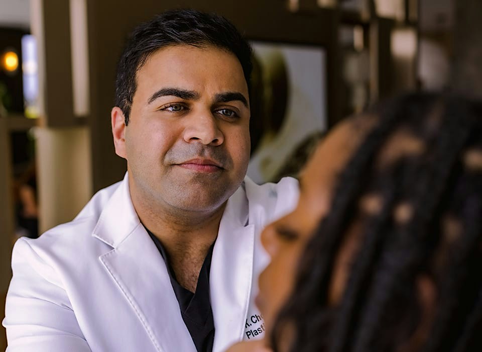 Dr. Chopra looking at patient