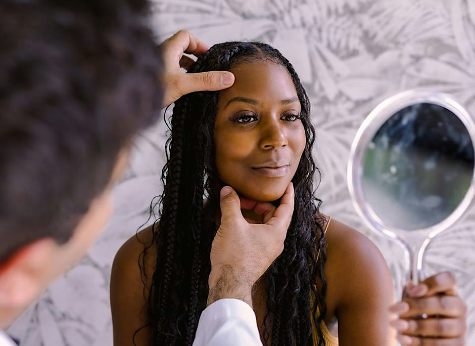 Dr. Chopra with patient looking at her eyelids
