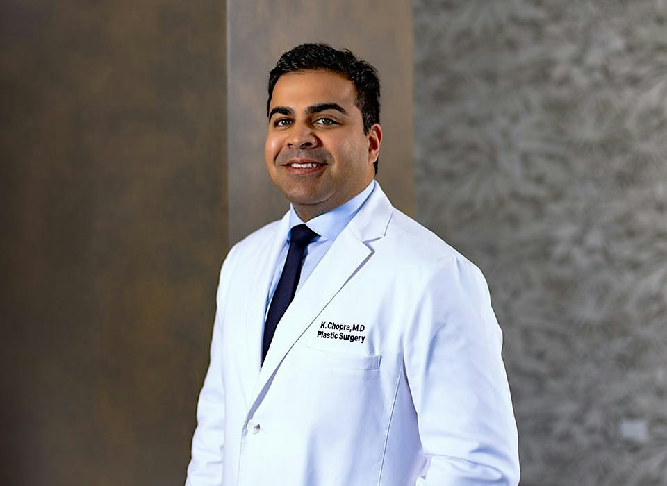Dr. Chopra in white medical suit