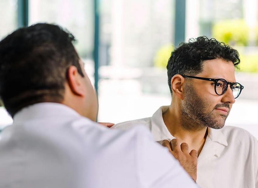 Dr. Chopra looking at side of patient's face