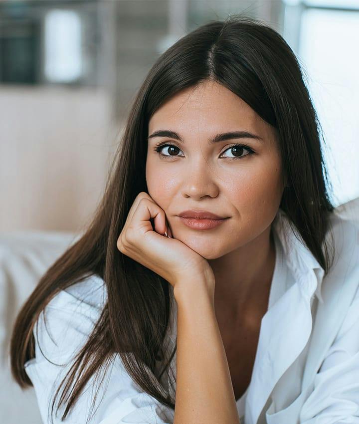 woman with long dark hair wearing a white shit