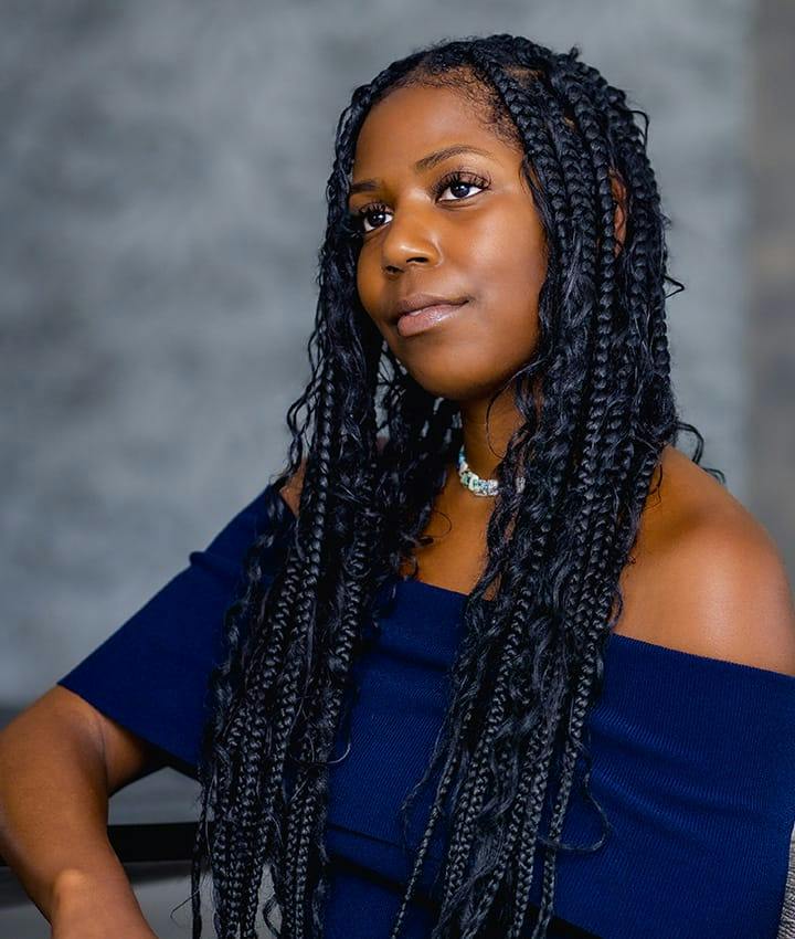 woman in navy blue dress sitting down