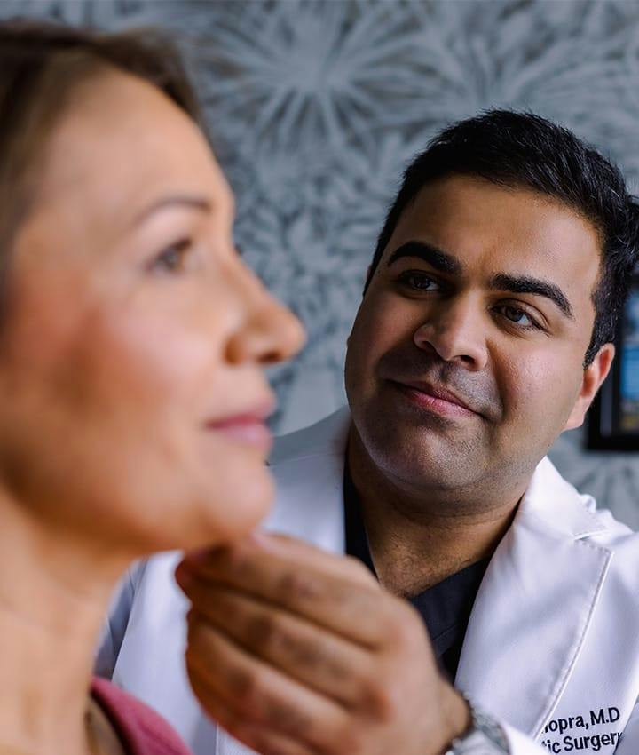 Dr. Chopra looking at patient's neck