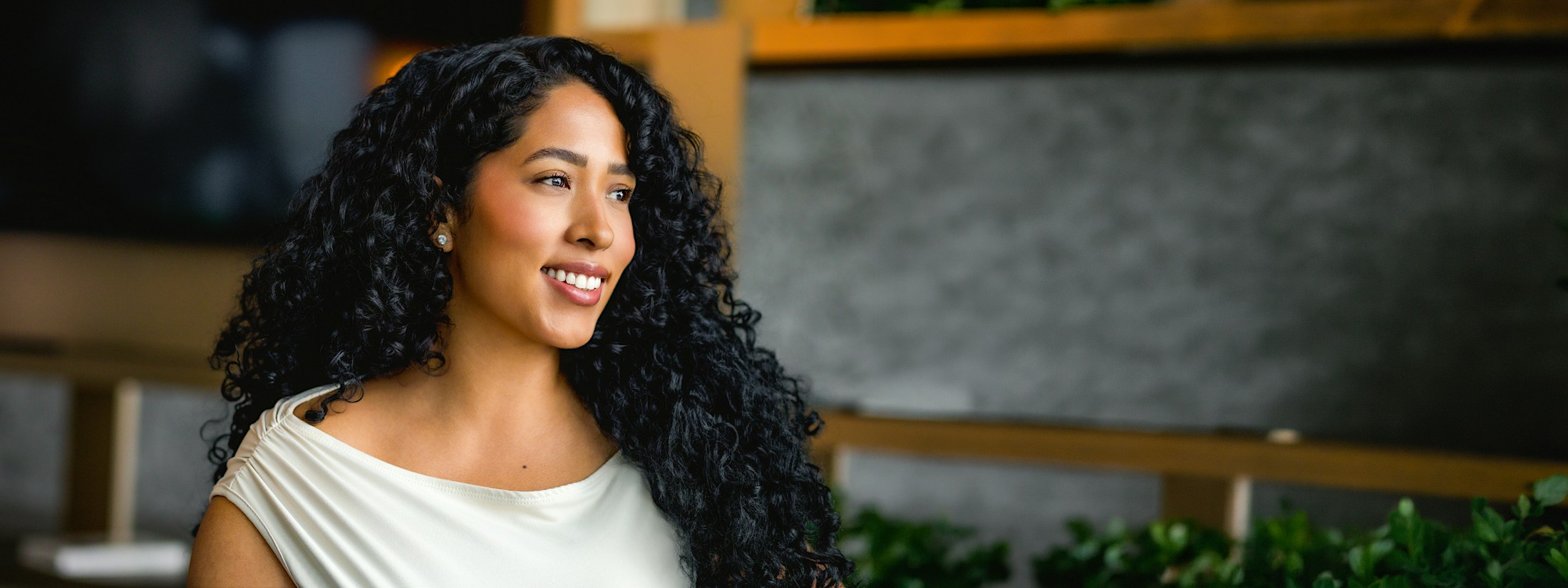 Woman with long curly hair smiling
