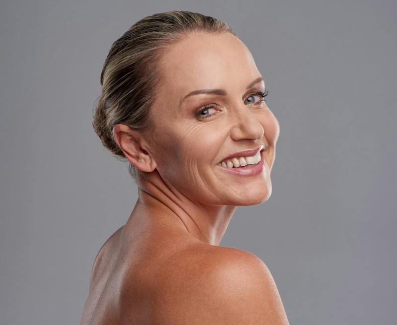 Woman smiling over her shoulder
