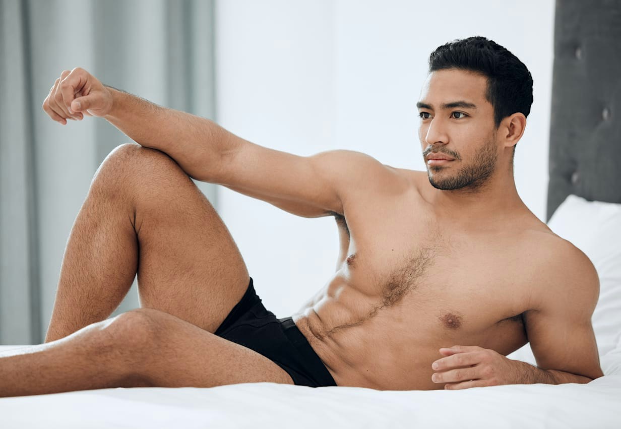 Man posing on bed
