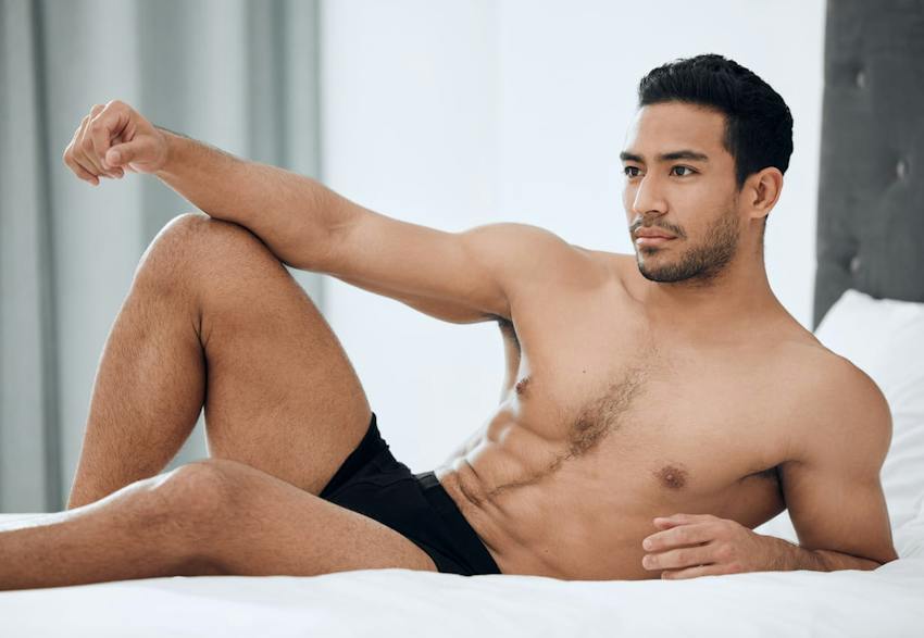 Man posing on bed