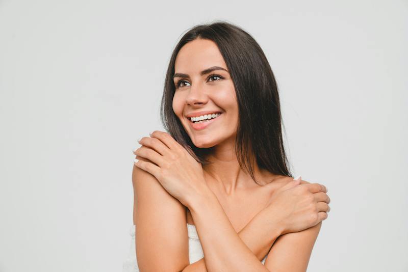 Woman smiling with arms crossed over her chest