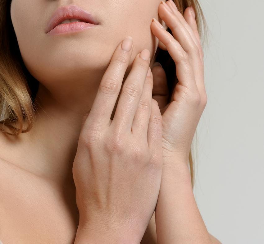 woman touching her cheek