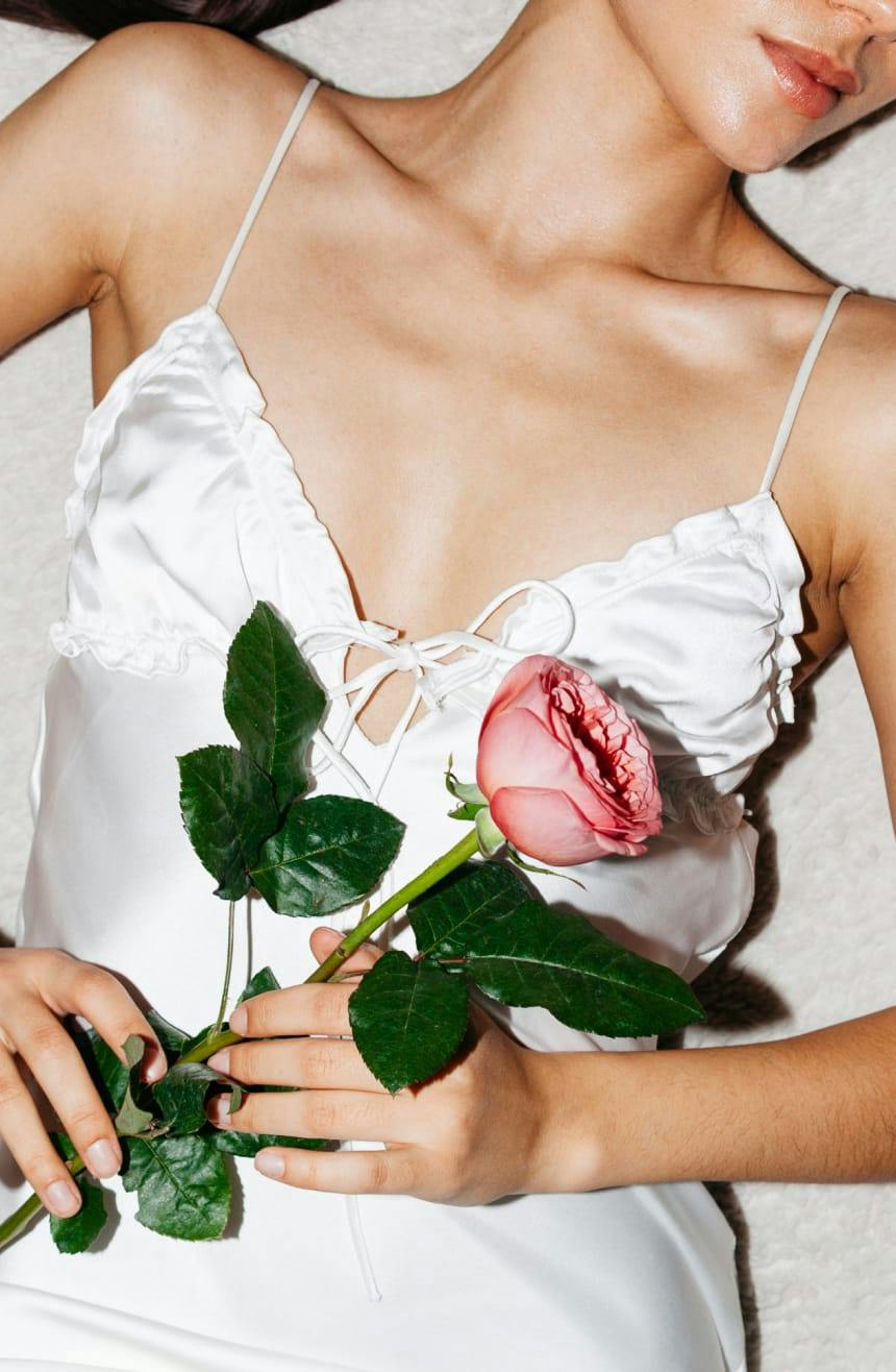 Woman holding a pink rose