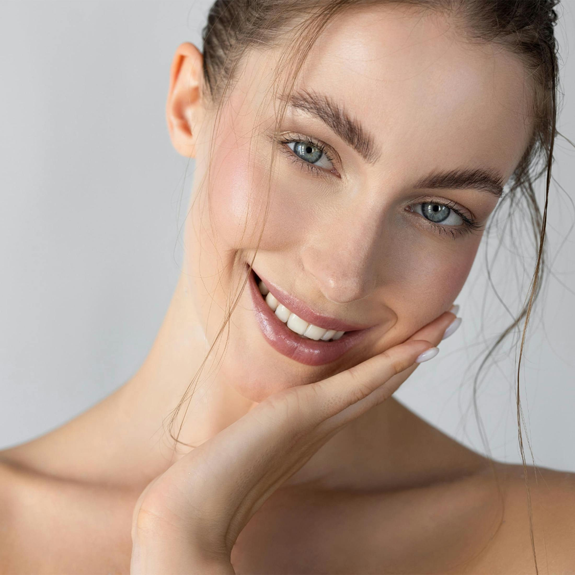 Woman smiling touching face