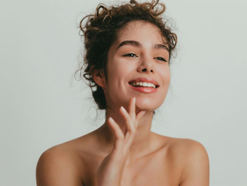 Woman smiling touching her chin