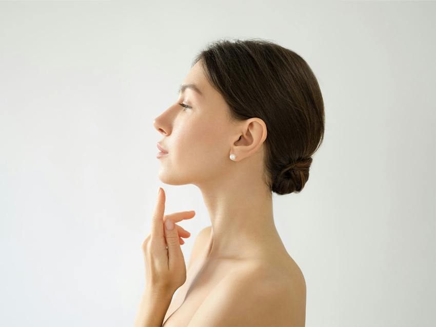 woman pointing to her chin