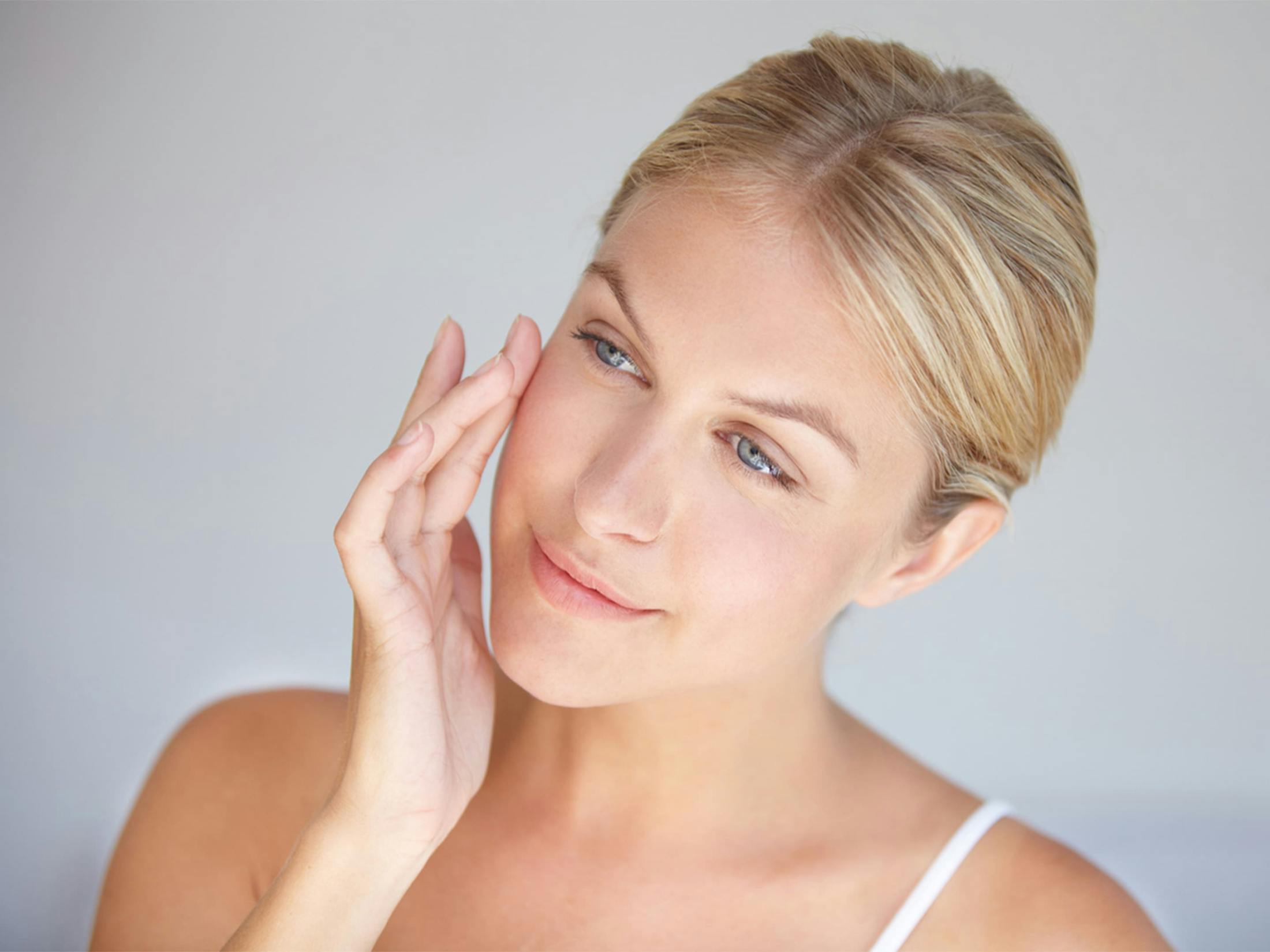 Woman smiling touching face