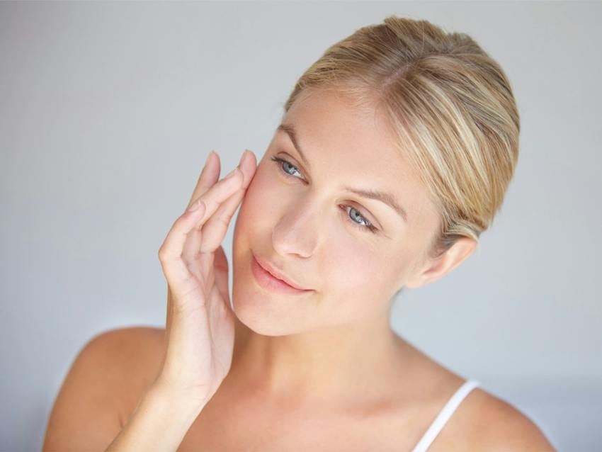Woman smiling touching face