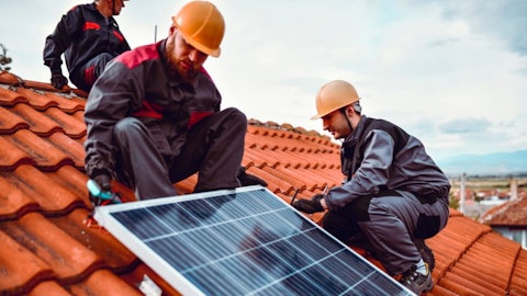 Installers on the roof with photovoltaic panels