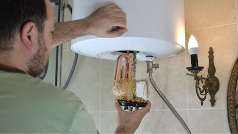 Instalator wymienia zakamienioną grzałkę boilera przez twardą wodę w instalacji