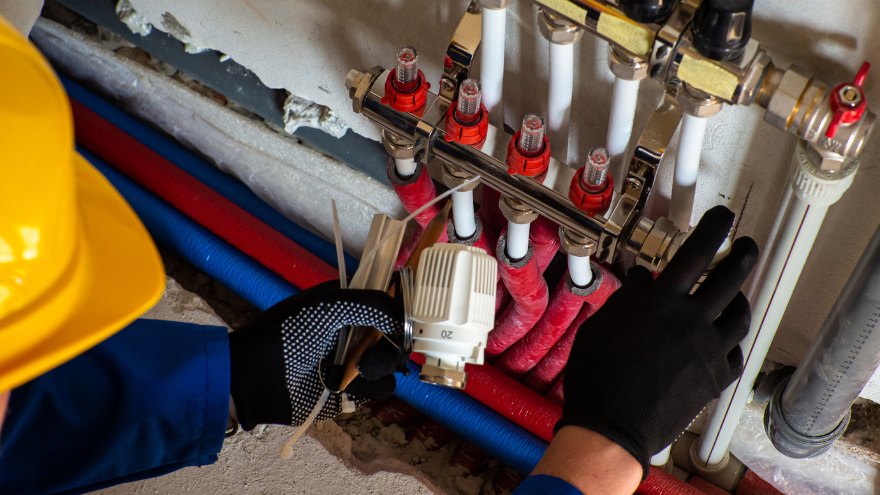 Instalator montuje do rozdzielacza ogrzewania podłogowego termostat
