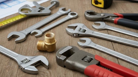 Zestaw narzędzi hydraulicznych i kluczy na drewnianym stole