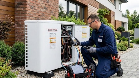 Serwisant wykonujący przegląd techniczny zewnętrznej pompy ciepła przy domu