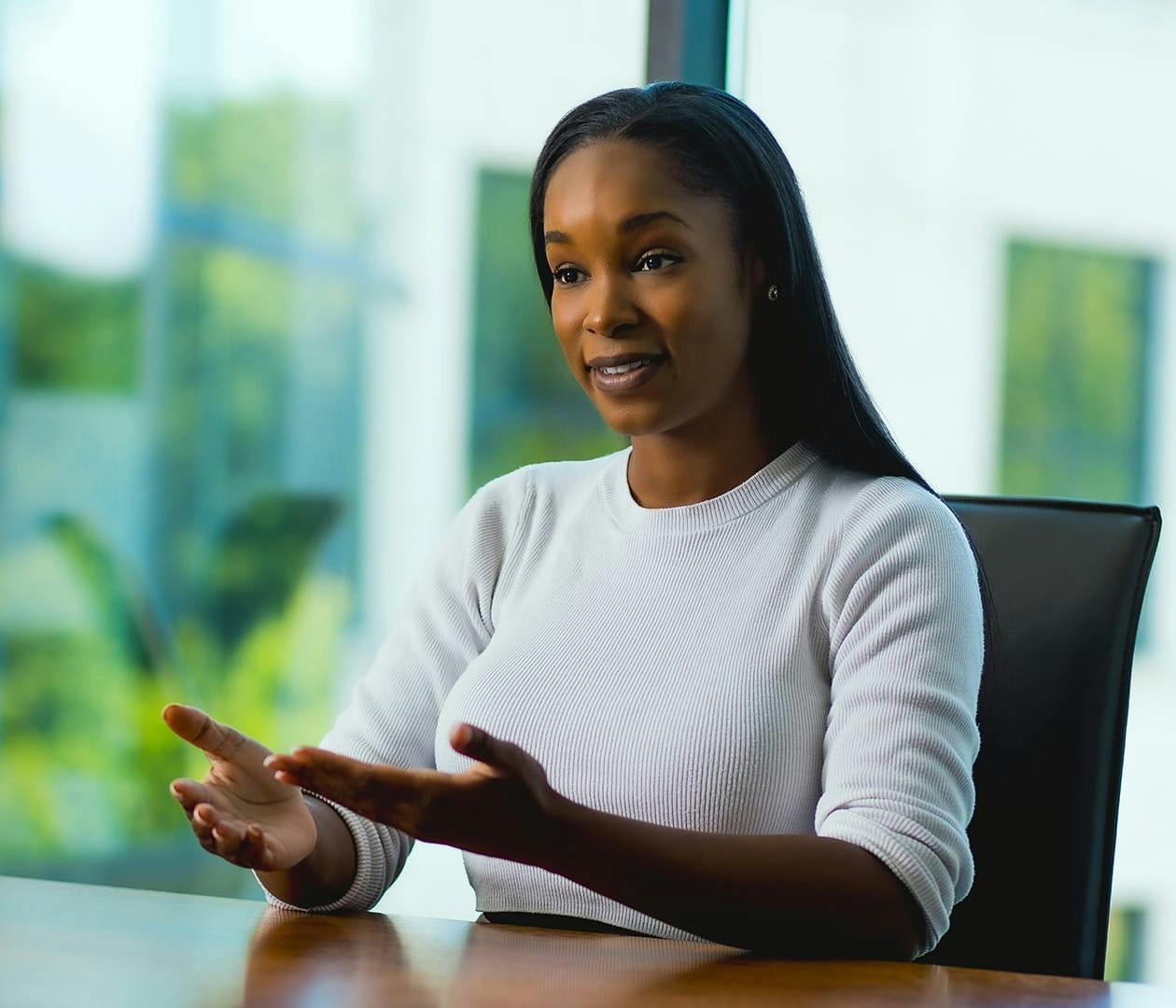 woman sitting at table with her hands out
