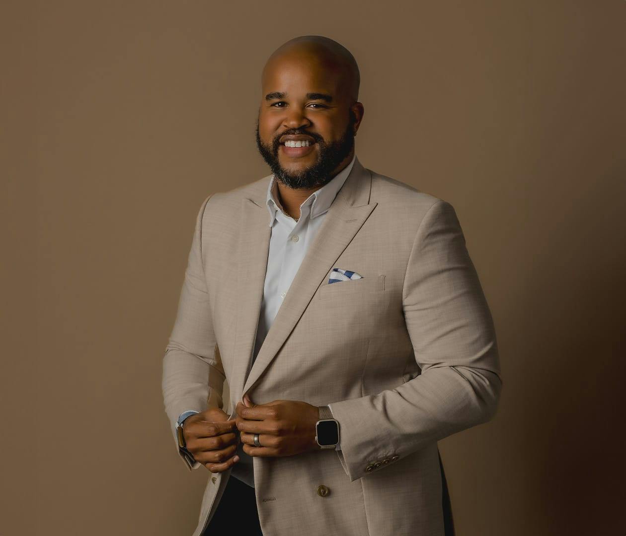 Kyle Jackson in beige suit
