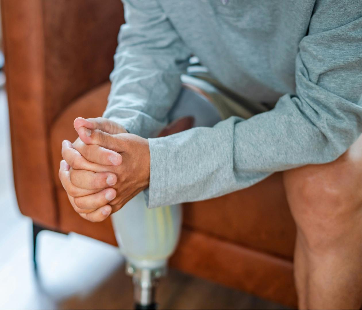 person with one leg sitting on a chair