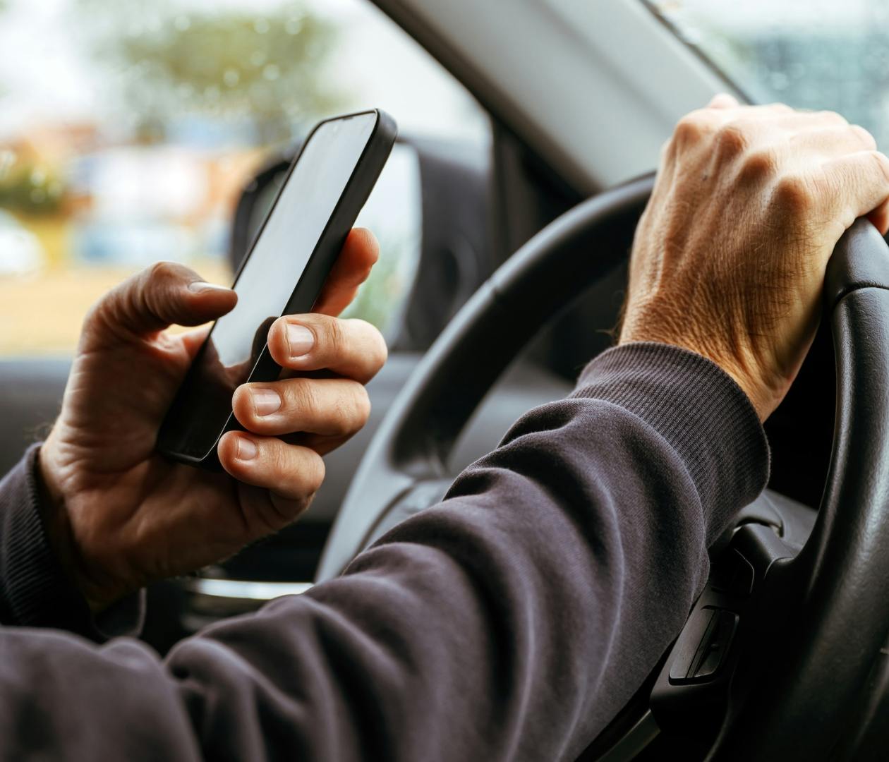 person on the phone while driving