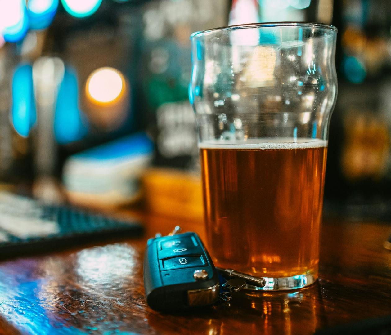 car keys and beer on a bar