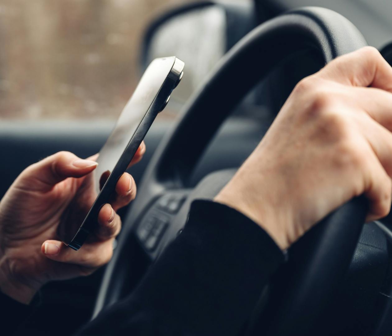 person texting while driving