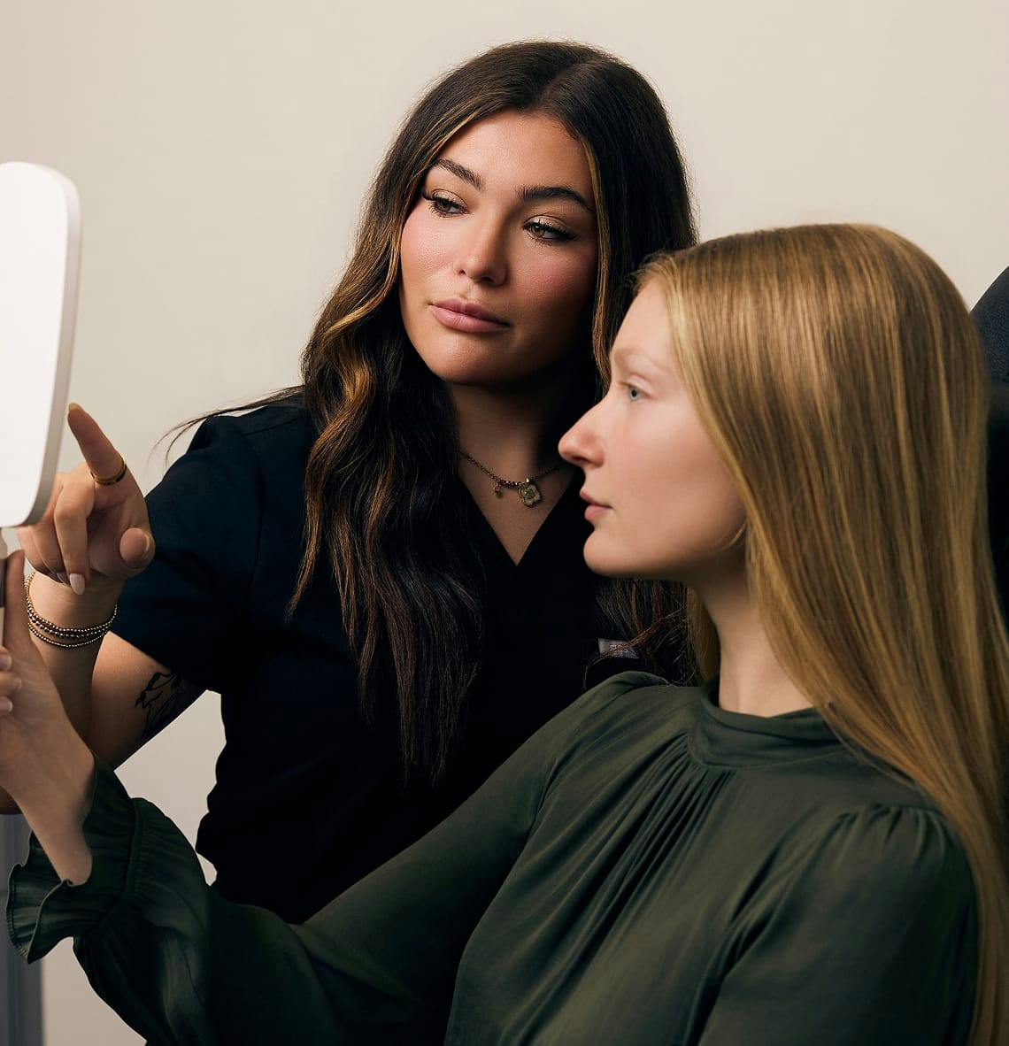 patient looking at herself in a handheld mirror