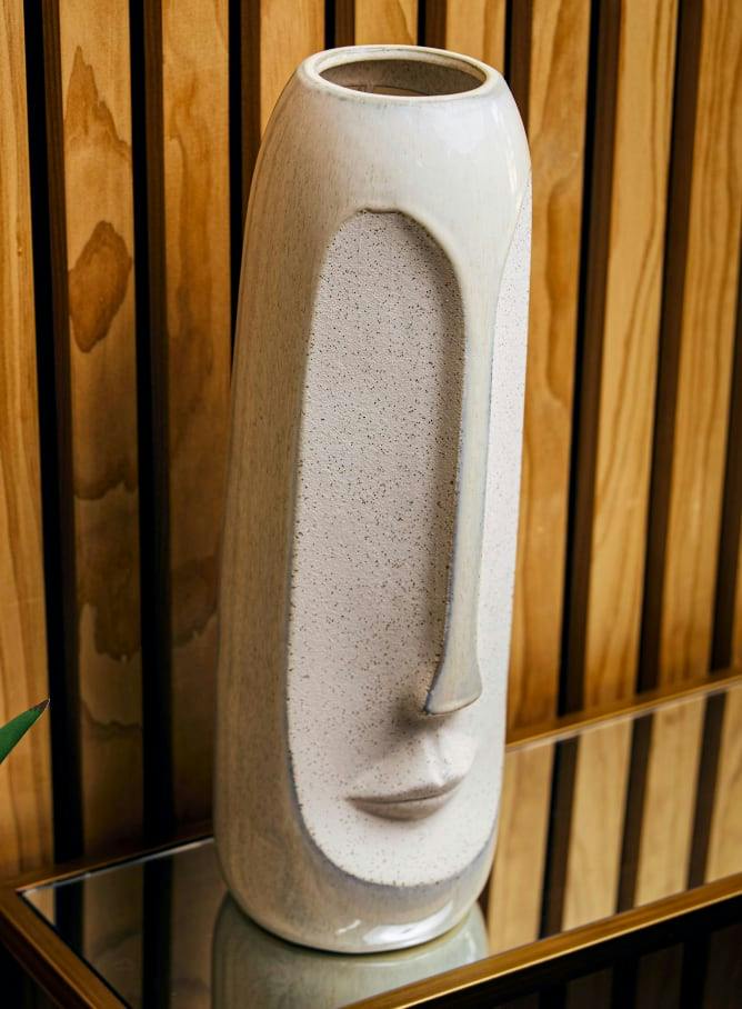 a face design on a vase