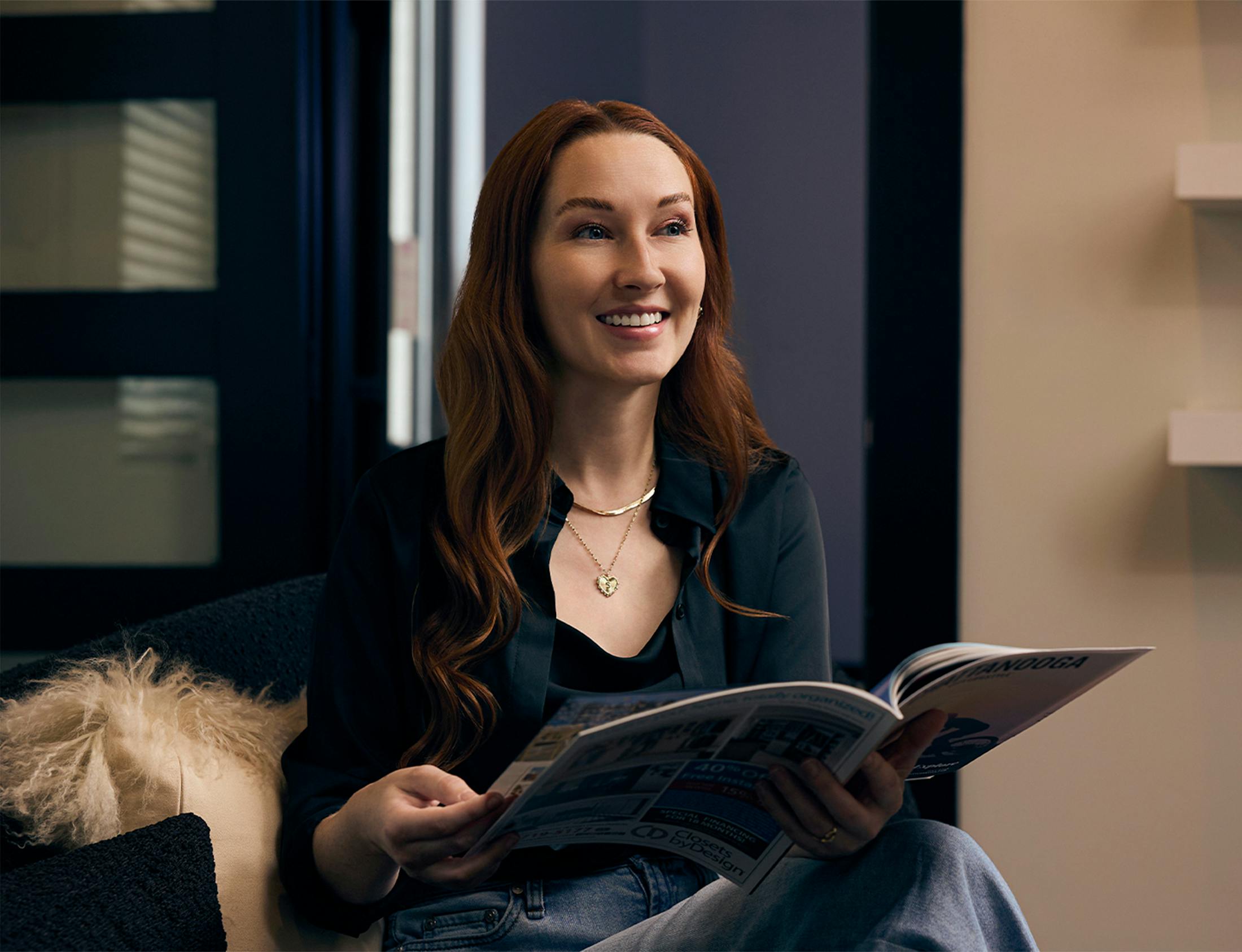 woman flipping through a magazine