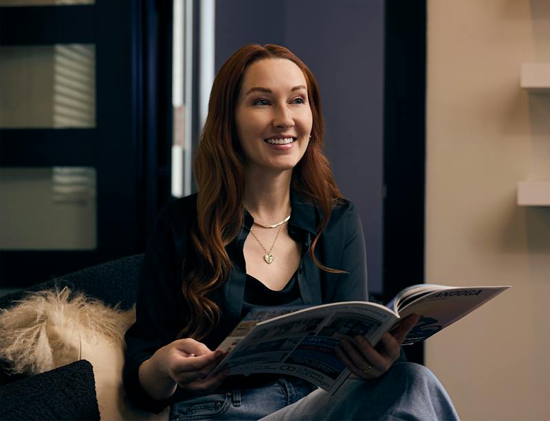 woman flipping through a magazine