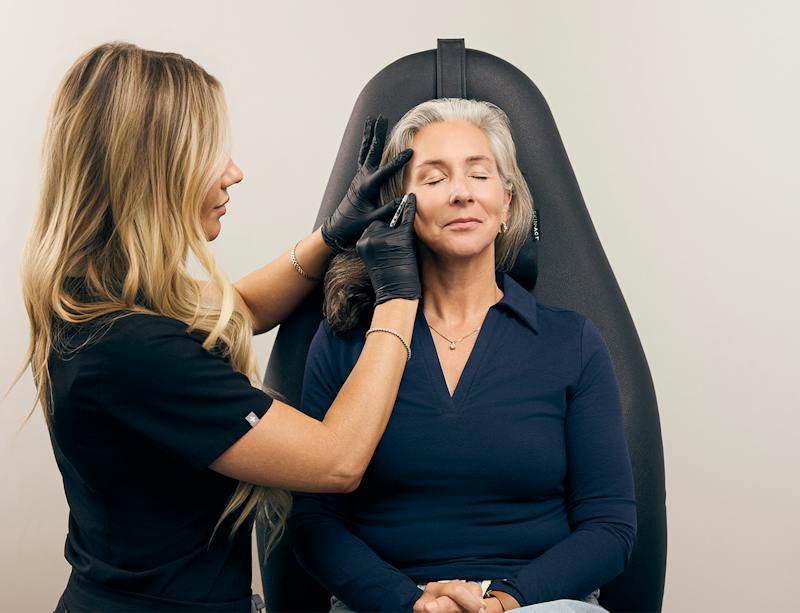 woman getting an injection in her face