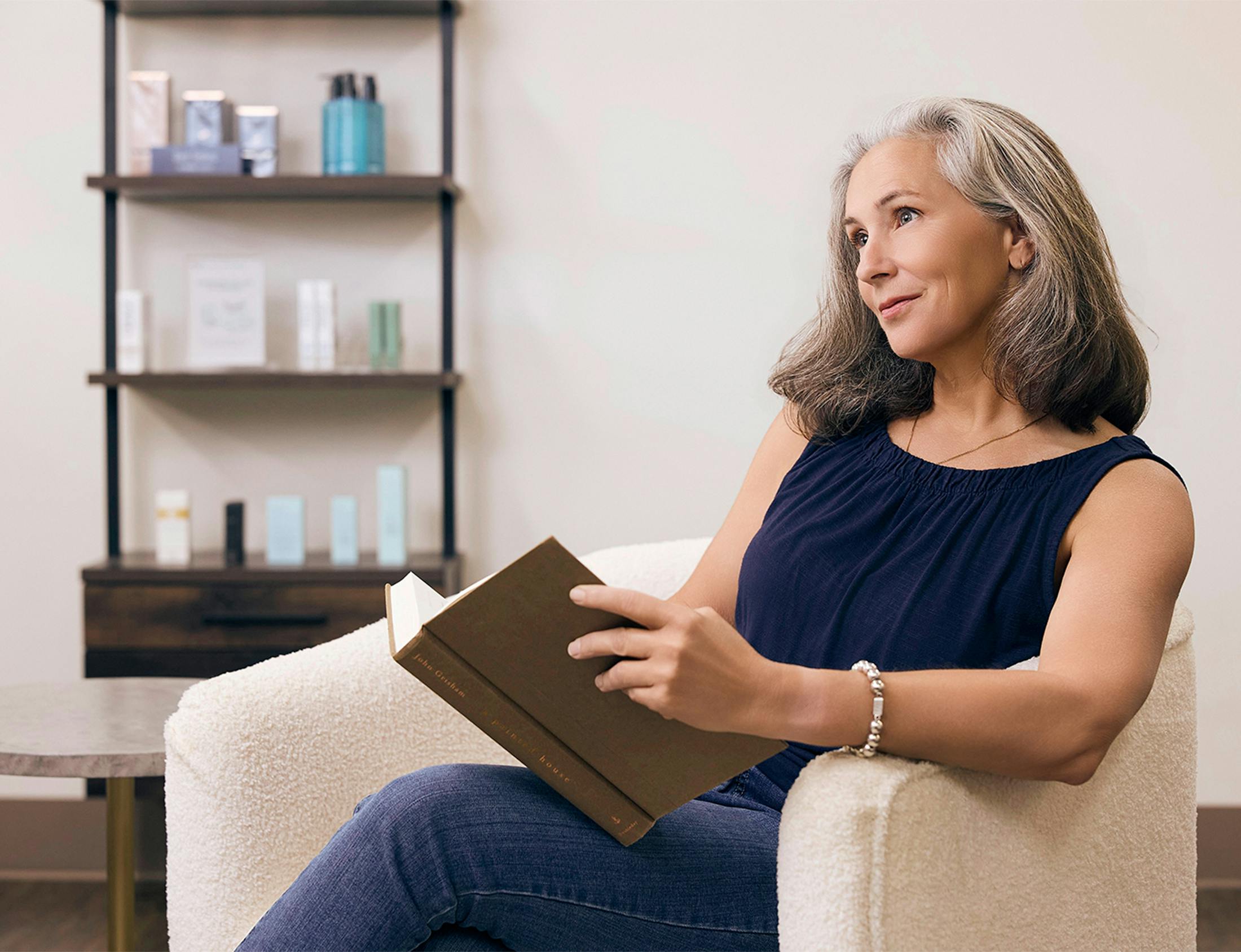 woman looking up from her book