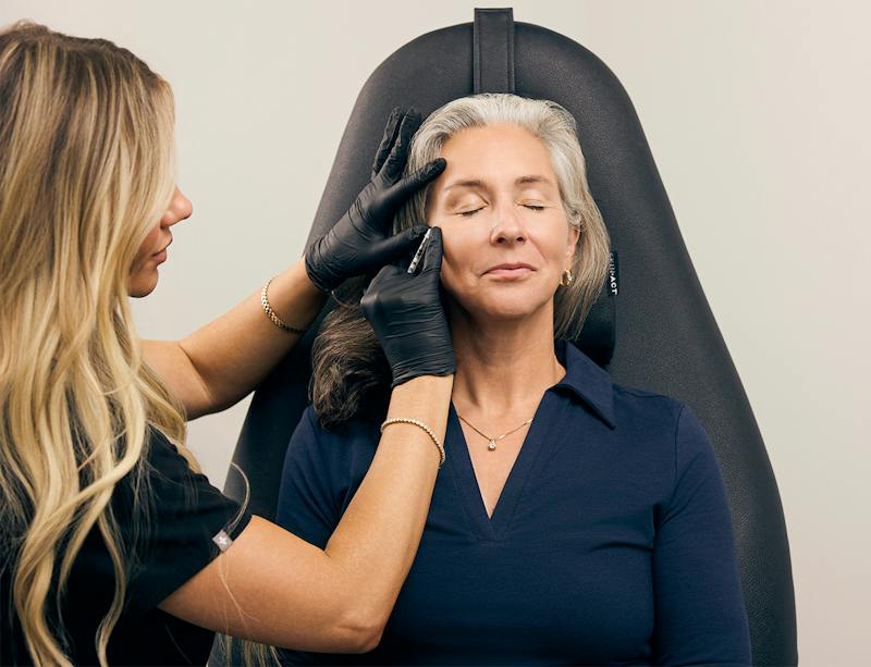 woman getting an injectable in her face