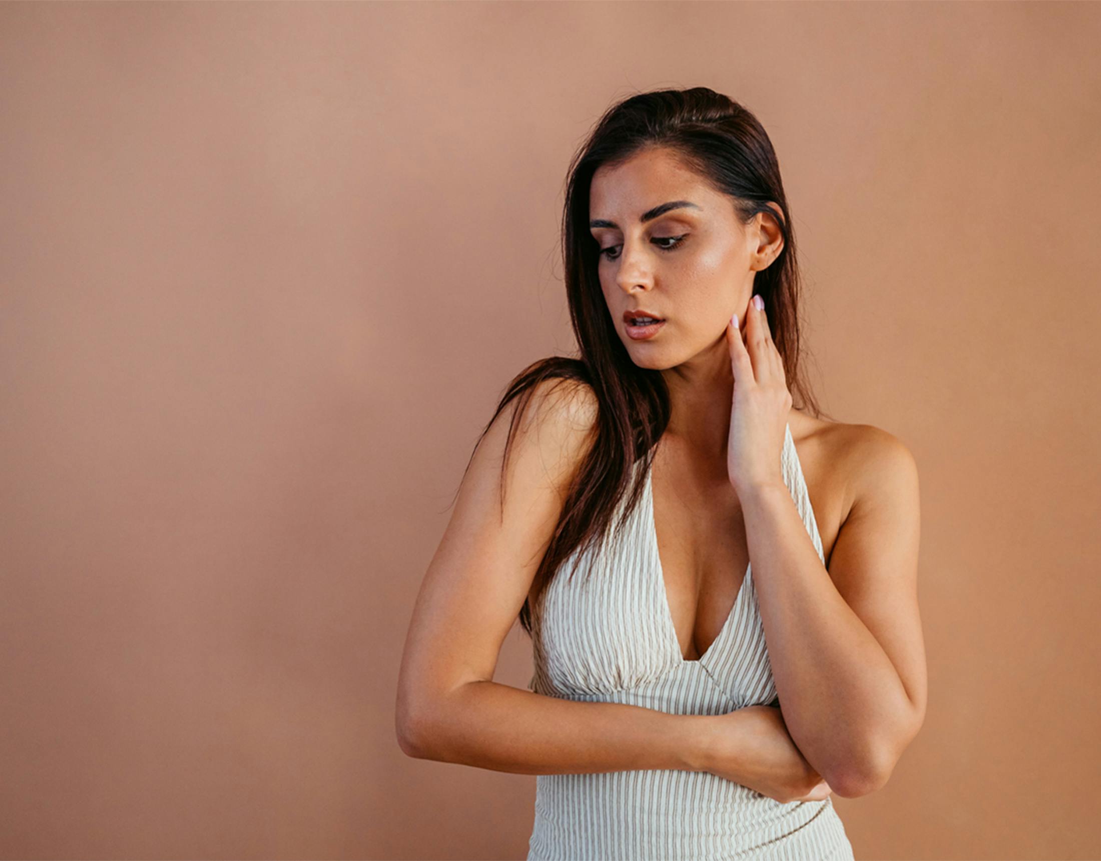 woman touching her neck