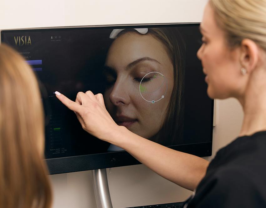 A woman pointing at a screen