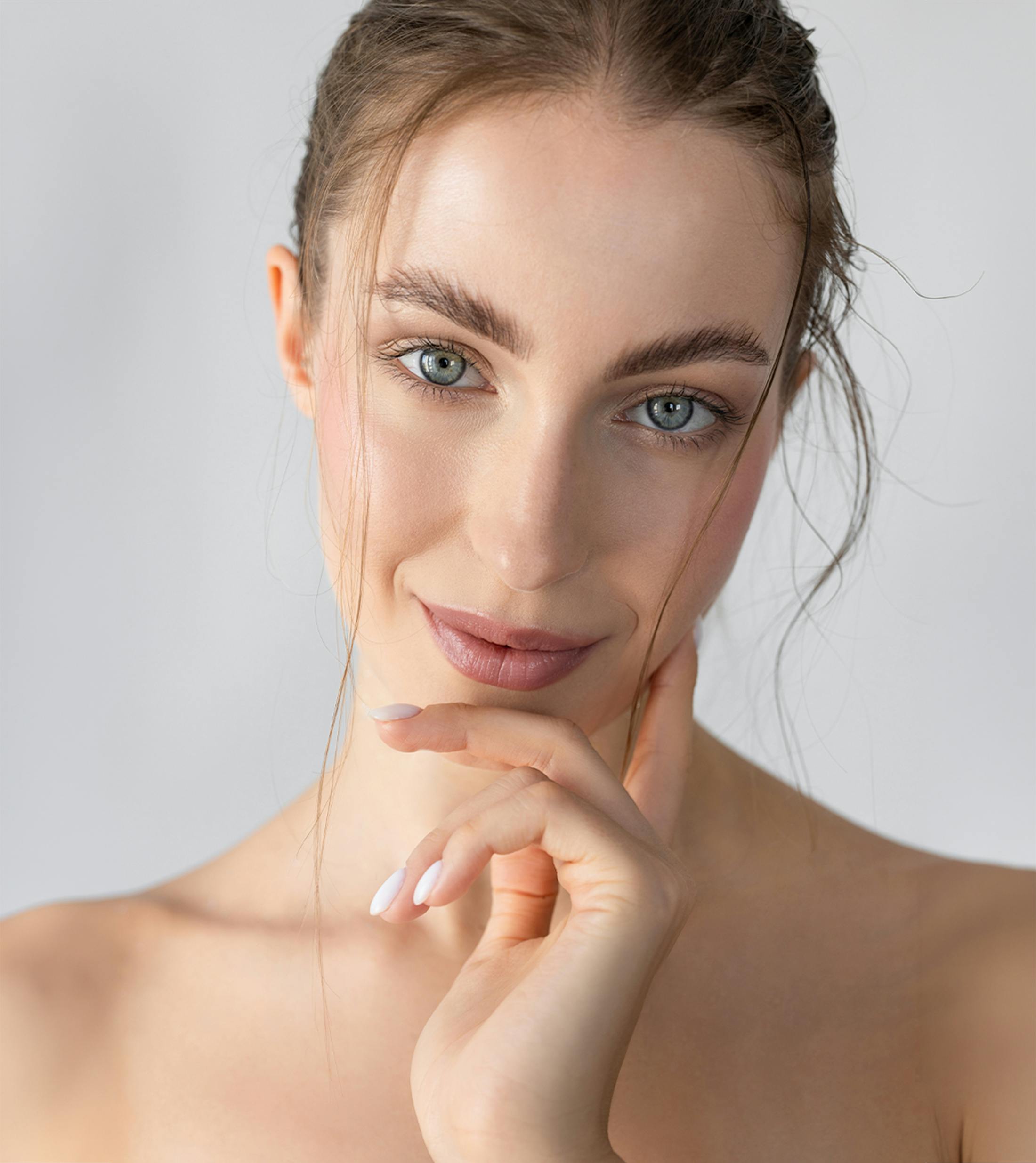 woman touching her cheek