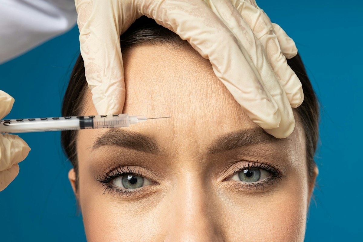 Close-up of patient receiving Dysport injection in forehead at Geneva Med Spa for smoothing dynamic wrinkles and achieving natural-looking results