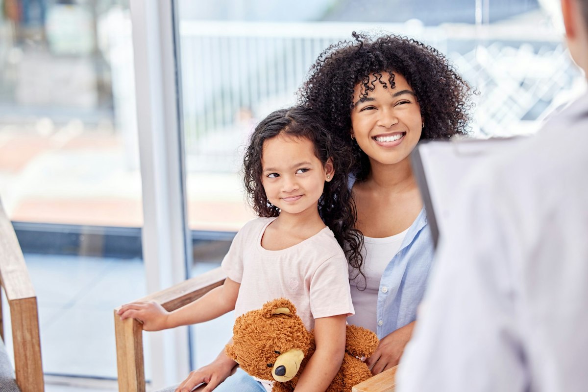 Parent and child meeting with a physician during a pediatric visit as part of a smooth transition to adult primary care at Geneva Med Spa in Alpharetta