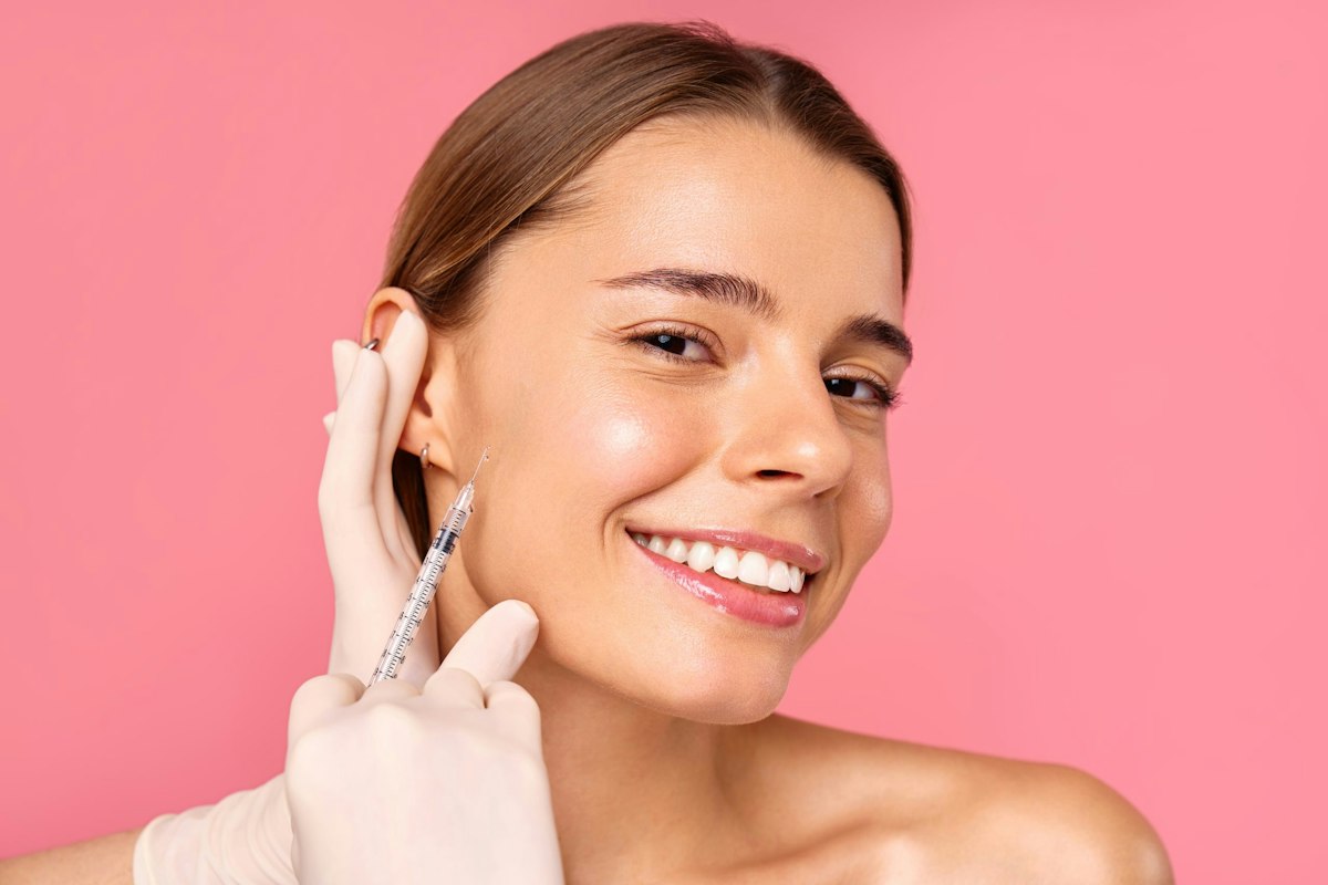 Smiling patient receiving physician led facial injectable treatment at Geneva Med Spa in Alpharetta